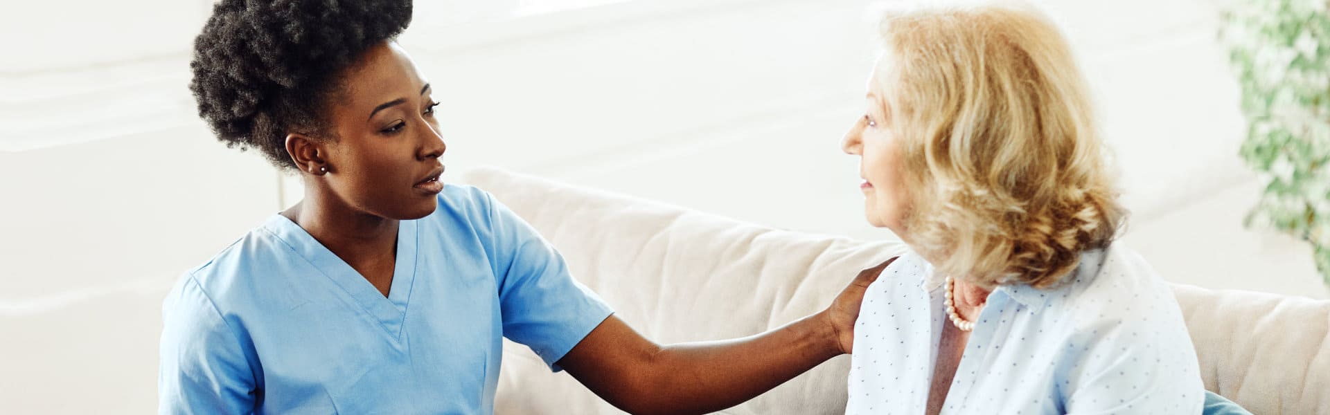 aide and senior woman having a conversation